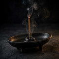 Cast Iron Canoe Smudge Pot with incense stick on dark background