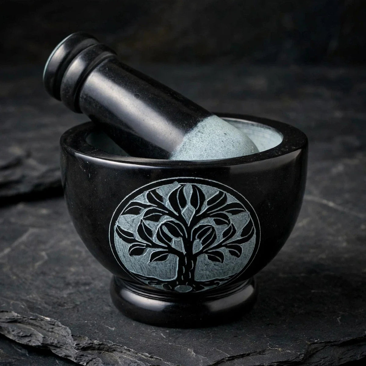 Tree of Life black soapstone mortar and pestle on dark slate