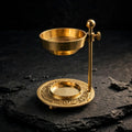 Brass resin burner on dark slate