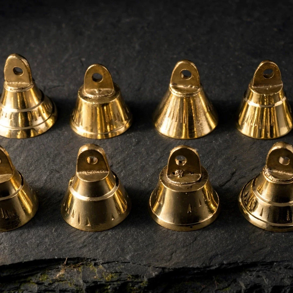 Mini brass bells on dark slate